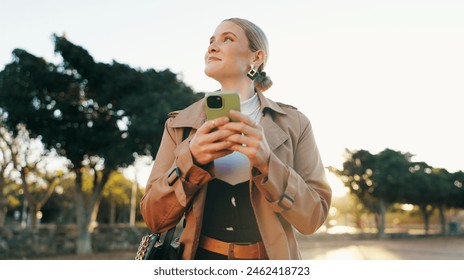 Businesswoman, cellphone and park walking for work commute in morning, notification or email. Female person, smartphone and thinking in urban nature in Boston with corporate, thoughts or decision - Powered by Shutterstock