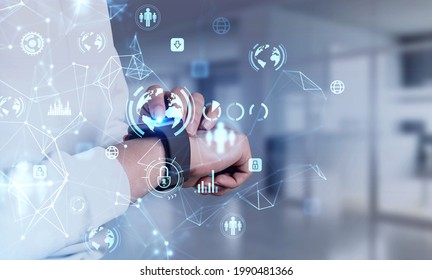 Businesswoman checking her smart watch to realize the status of data protection and personal confidential information. Blue glowing icons. Padlock and business symbols. Concept of cyber security - Powered by Shutterstock