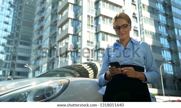Businesswoman checking message on cellphone smiling,
success in life and
work