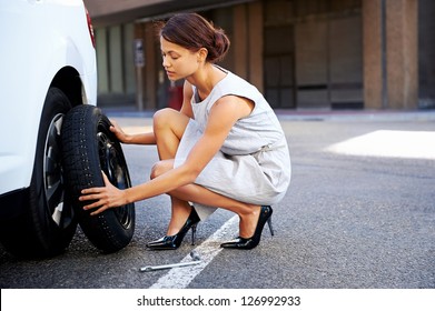 Girl Changing Tyre