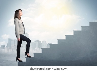 Businesswoman climbing up a concrete staircase concept on city background