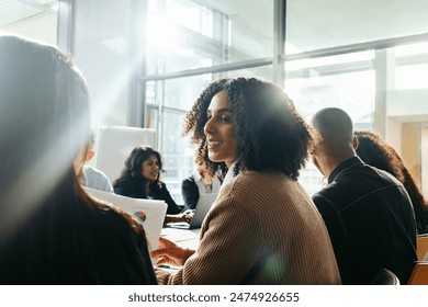 Businesswoman collaborating with diverse group of colleagues, engaging in a productive business meeting in a contemporary office. Teamwork, brainstorming, and collaboration in a bright workspace. - Powered by Shutterstock