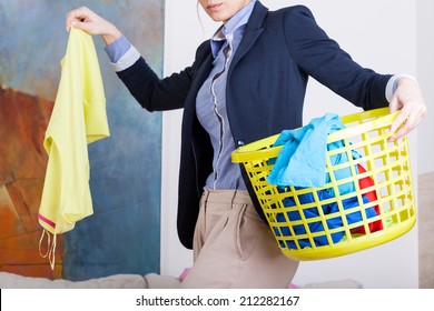 Businesswoman collecting dirty clothes before going to work