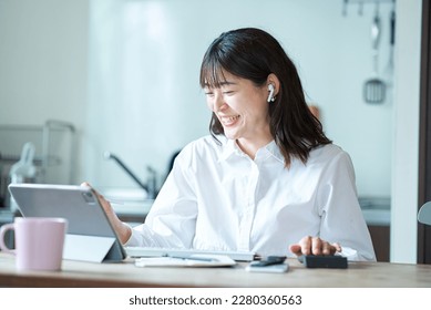 Businesswoman communicating online in her living room - Powered by Shutterstock