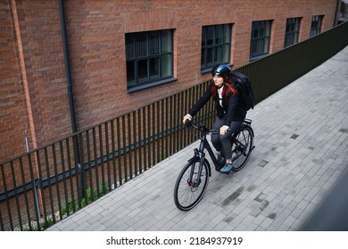 Businesswoman Commuter On The Way To Work On Bike, Sustainable Lifestyle Concept. High Angle View.