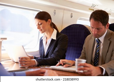 Businesswoman Commuting To Work On Train And Using Laptop