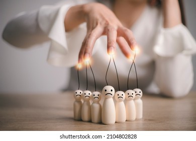 Businesswoman Controlling Wooden Figures And Manipulating Concept