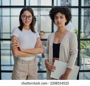 Businesswoman with coworker standing in modern office - Shutterstock ID 2208314523