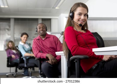 Businesswoman And Co-workers Working In Cubicles