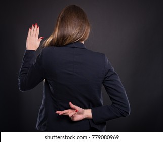 Businesswoman with crossed fingers behind her back making a false promise - Powered by Shutterstock