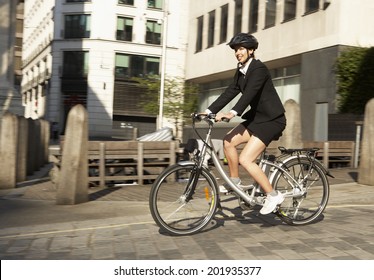Businesswoman cycling to work