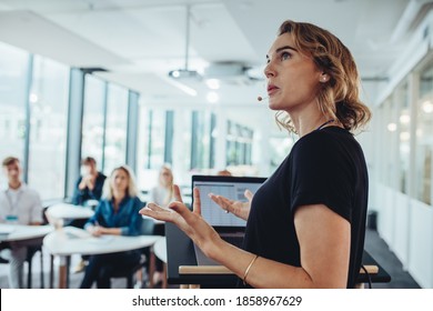 Businesswoman delivering a presentation at a conference. Female entrepreneur sharing new business ideas in a conference. - Shutterstock ID 1858967629