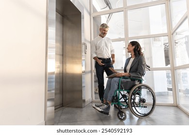 Businesswoman with disabilities with man posing in office hall - Powered by Shutterstock