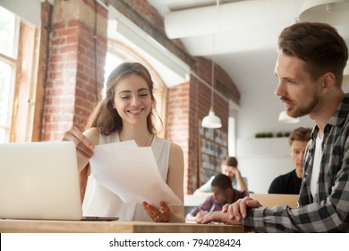 Businesswoman Discussing Business Documents At Meeting With Client Customer In Shared Office, Smiling Woman Employee Helping Mentoring Young Man Intern Explaining Corporate Paperwork In Co-working