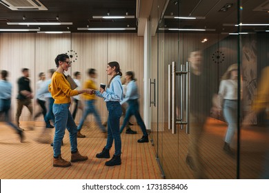 Businesswoman Discussing On Background Of Crowd Office Employees At Coworking Center. Business People At Motion Blur. Concept Of Working At Action. Group Of Coworkers At Open Space