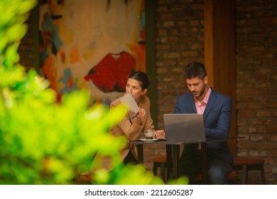 A Businesswoman Was Distracted While She Was Talking To Her Business Boyfriend. He Is Checking His Phone