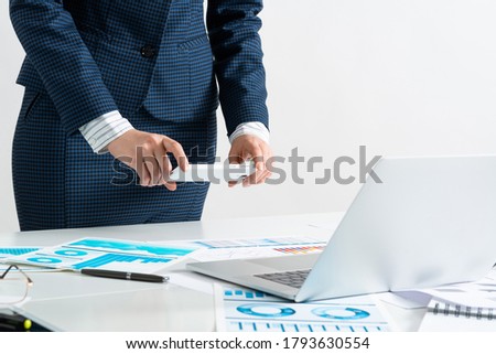 Businesswoman doing photo of paper document with smartphone. Online stock trading and investment. Manager in suit working with business analytics. Digital technology in business. Corporate espionage