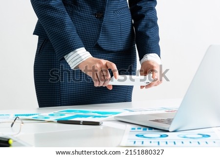 Businesswoman doing photo of paper document with smartphone. Online stock trading and investment. Manager in suit working with business analytics. Digital technology in business. Corporate espionage