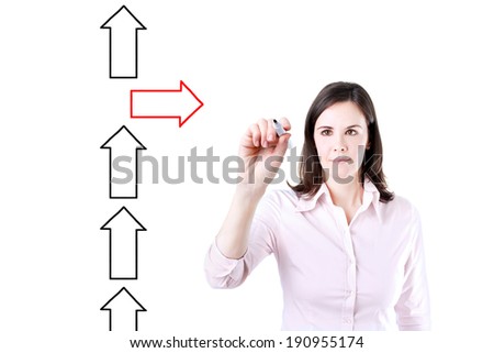 Businesswoman drawing arrows in different directions.