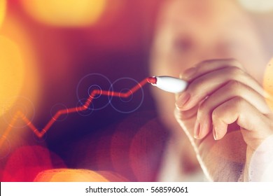 Businesswoman drawing rising graph for successful positive business results and corporate profit growth