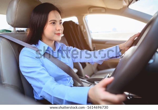 businesswoman, driving, multitasking, car,\
lifestyle concept. Businesswoman multitasking while driving car\
working and talking on cell phone on the\
road.