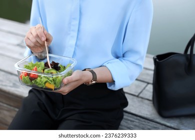 Businesswoman eating lunch during break outdoors, closeup - Powered by Shutterstock