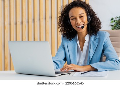 Businesswoman with elegant suit sitting at computer desk in the office and joining in a video conference - Beautiful adult woman working at laptop and telephone online for a customer care company - Shutterstock ID 2206166545