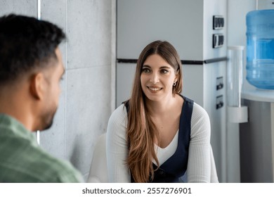 Businesswoman engaging in a positive interaction with a male colleague, fostering teamwork and collaboration in a professional office setting - Powered by Shutterstock