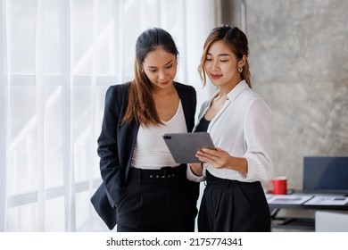 Businesswoman Executive Is Using A Tablet In Meeting Discussion With Another Businesswoman Or Client In Modern Workplace Office. People Corporate Asian Business People Team Concept.