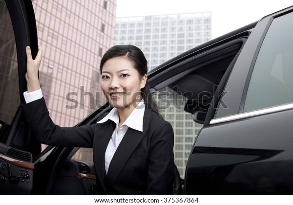 Businesswoman exiting a\
car