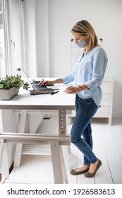 Businesswoman With Ffp2 Mask Working At Ergonomic Standing Desk.