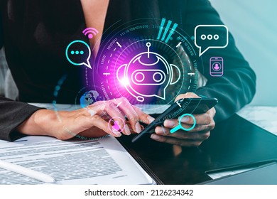 Businesswoman finger touch smartphone, hologram of voice chat. Bot icon and social network signs. Office table with papers. Concept of communication and support