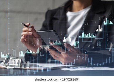 Businesswoman in formal wear is signing the contract to invest money in stock market. Internet trading and wealth management. Checking the details of transaction at smart phone. Forex - Powered by Shutterstock