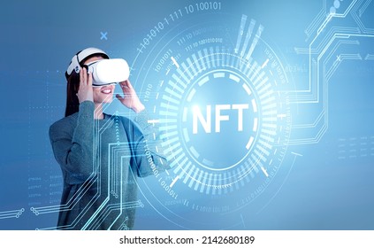 Businesswoman in formal wear and vr helmet is watching at digital interface with non-fungible token hologram on virtual screen, nft with network. Blue background. Concept of cryptoart and technology