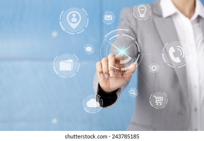Businesswoman in front of visual touch screen.