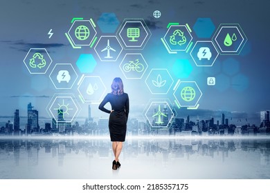 Businesswoman Full Length Back View Looking At New York Skyline, Glowing Green Energy Hud With Diverse Icons. Concept Of Eco Technology