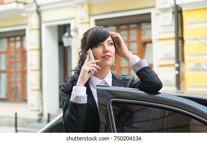 Business-woman Gets Into The Car And Talks On Mobile Phone