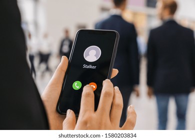 Businesswoman Gets A Phone Call From A Stalker. Stalking Or Bullying With Smartphone Concept. Stalker Caller, Scammer Or Stranger. Woman Answering To Incoming Call. Ex Boyfriend With Fake Identity.