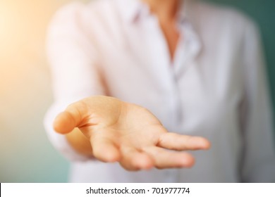Geschäftsfrau, die eine Hand auf unscharfem Hintergrund gibt 