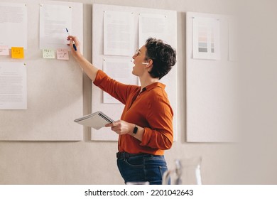 Businesswoman Giving A Presentation During An Online Conference Call. Creative Female Designer Pitching Her Strategy In A Virtual Meeting. Mature Businesswoman Working Remotely In An Office.