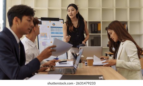 Businesswoman giving a team presentation with charts and data visuals in a bright modern office. - Powered by Shutterstock - Get 15% off with code: PIKWIZARD15