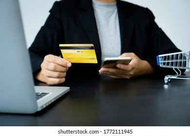 Businesswoman Hand Using Mobile Smart Phone And Creditcard, Onlinepayment, Banking And Online Shopping At The Home Office.