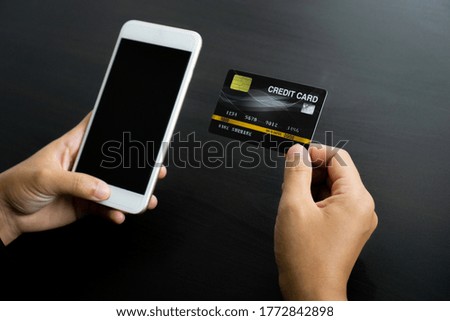 Businesswoman hand using mobile smart phone and creditcard, onlinepament, banking and online shopping at the home office.