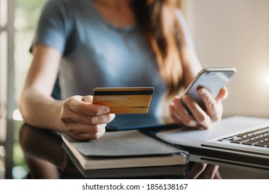 businesswoman hand using smart phone, tablet payments and holding credit card online shopping, omni channel, digital tablet docking keyboard computer at office