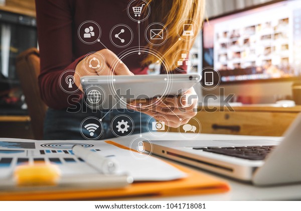  businesswoman hand working with laptop computer, tablet and smart phone in modern office with virtual icon diagram at modernoffice in morning light 