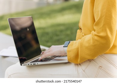 Businesswoman Hands Busy Working On Laptop Computer For Send Emails And Surf On A Web Browser. Hands Of Unrecognizable Girl Working Outside At Modern Office On Background. Concept Of Work At Computer.