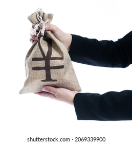 Businesswoman Hands Holding A Money Bag With Chinese Yuan Sign.