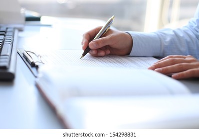 Businesswoman hands pointing at business document