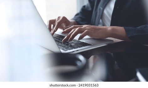 Businesswoman hands typing on laptop computer keyboard, online working at modern workplace. Woman surfing the internet on laptop, working remotely at home office, teleworking, distant job - Powered by Shutterstock