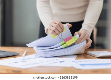 Businesswoman hands working with document papers at work desk in office. - Shutterstock ID 2363813199